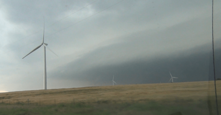 Lots of energy coming out of the El Reno supercell. Video capture from the south looking across wind farm near Union City