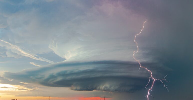 A bolt of lightning strikes ahead of a beautifully sculpted mesocyclone on a storm near Sublette, Kansas on May 21, 2020